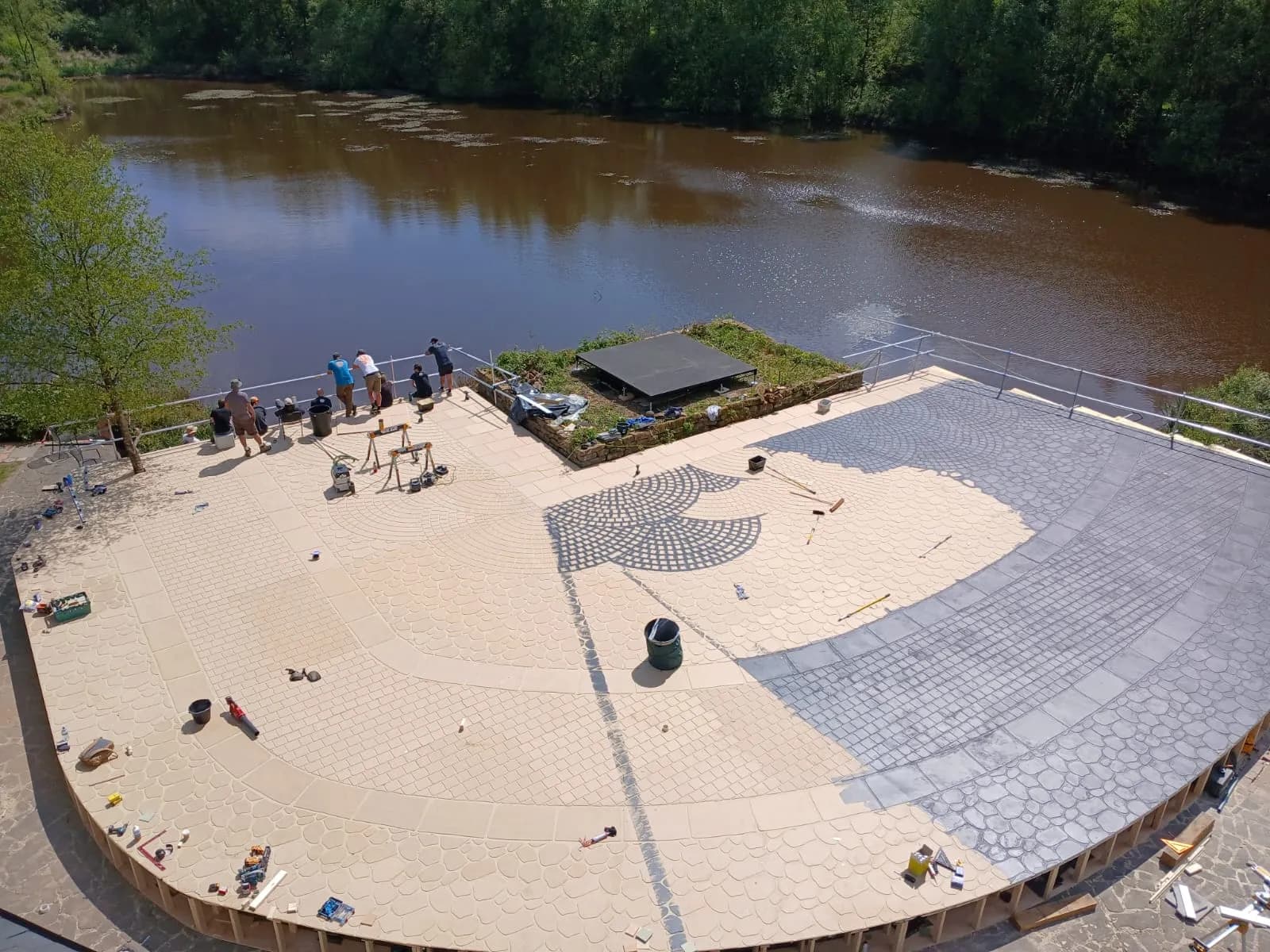 Location build in progress on a riverside terrace
